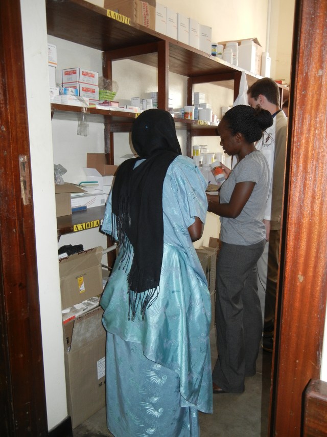 Vicky dispenses medication and provides education to a caregiver for one of the patients; notice the beautiful outfit- I thought this woman might have "dressed up" to come to the hospital but I was told that this is her normal, everyday traditional garment. 