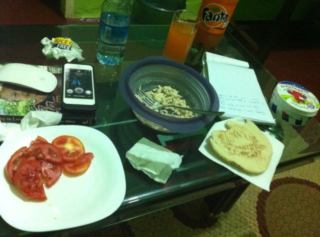 A dinner of tuna with pita and sliced tomatoes while I work at my computer in the living room