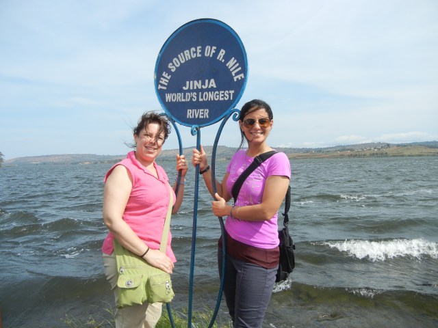 KarenBeth and Sammi at the Source of the Nile sign.  Behind us lies Lake Victoria and in front of us, towards the bottom left-hand corner of the picture flows the Nile River.