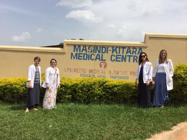 Amanda, Lizzie, Kristen and Hanna outside the entrance to Masindi-Kitara Medical Center, Masindi, Uganda