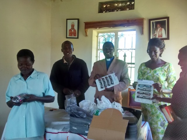 Janine hands out the glasses- The Rev Bishop Julius Caesar was one of the grateful recipients