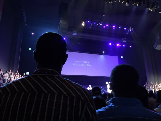 The singing begins...notice the choir standing on both sides of the stage up front. It was quite large- I think maybe 75 people. The women are in black and white polka dotted dresses.