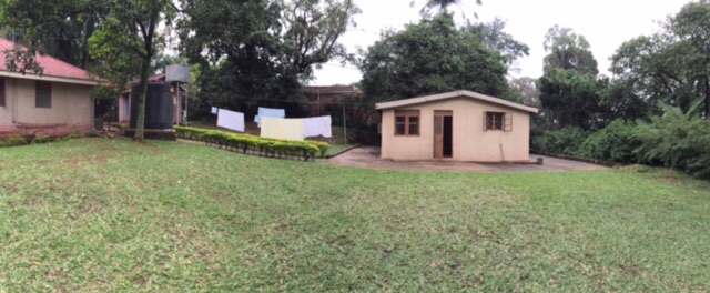 The small house to the right of the photo is my home away from home in Kampala.